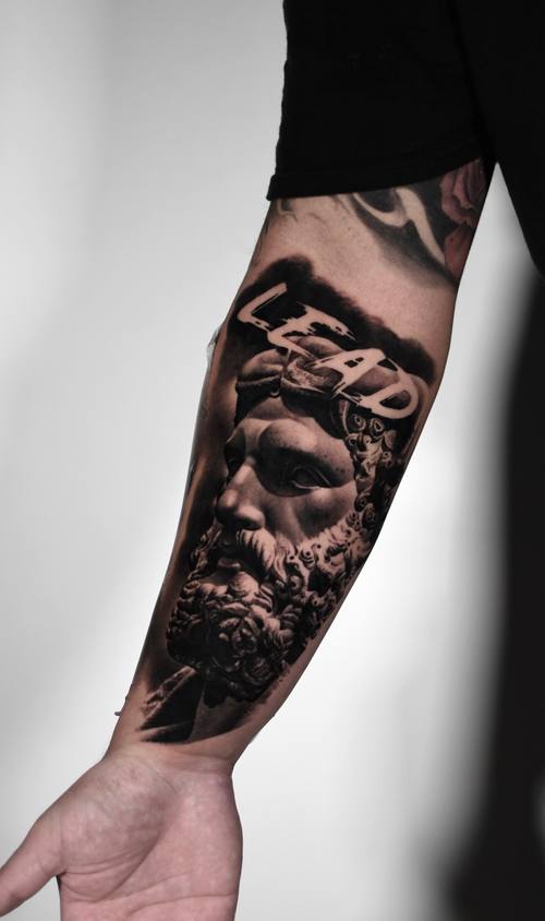 Bearded classical statue with LEAD lettering, black and grey forearm sleeve