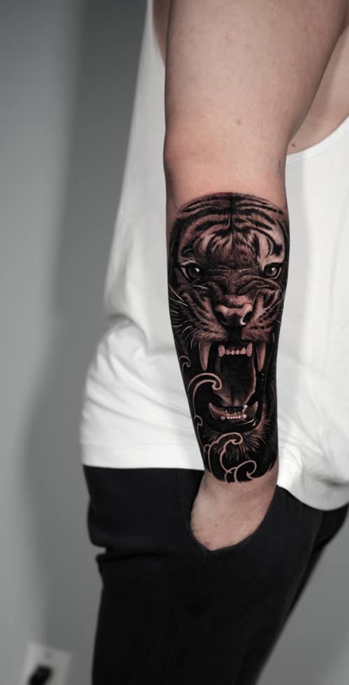 Roaring tiger, black and grey realism forearm tattoo