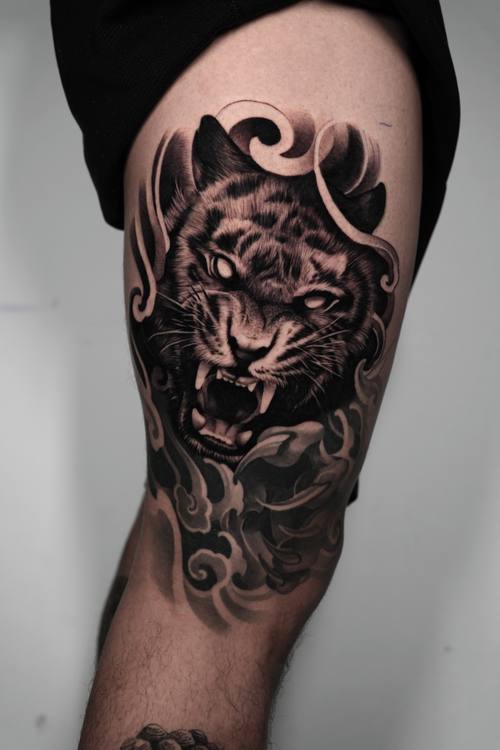 Roaring tiger with smoke ornament, black and grey thigh tattoo