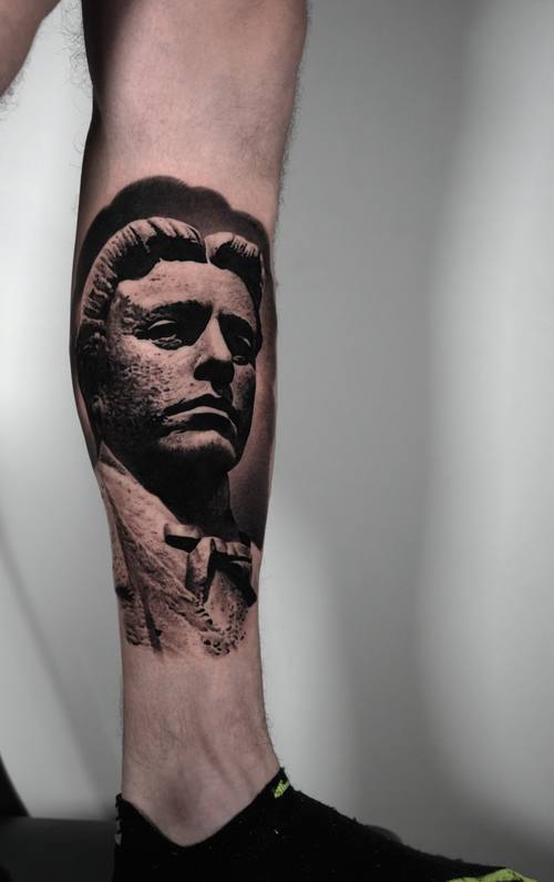 Marble statue portrait of a young man, black and grey realism shin tattoo