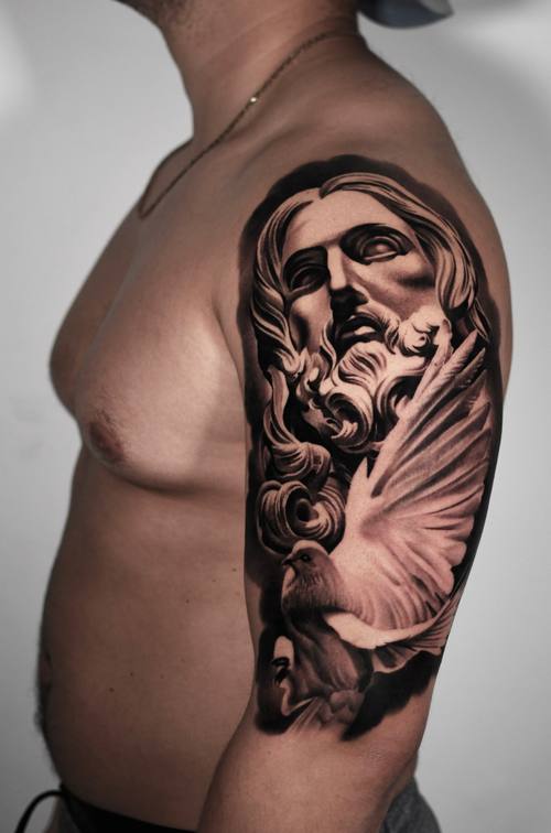 Christ portrait, black and grey upper arm tattoo
