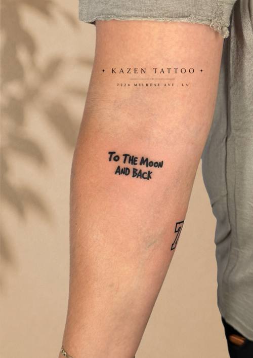 Script reading To The Moon And Back on the forearm by Amina at KAZENTATTOO, Los Angeles