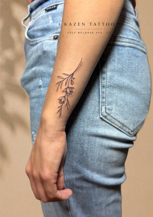 Fine line botanical along the side of the body by Amina at KAZENTATTOO, Los Angeles