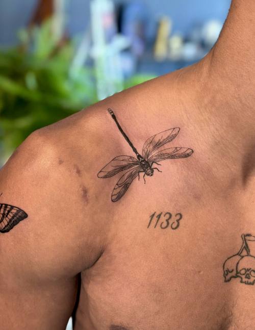 Dragonfly with numerals on the shoulder blade, fine line tattoo by Amina at KAZENTATTOO, Los Angeles