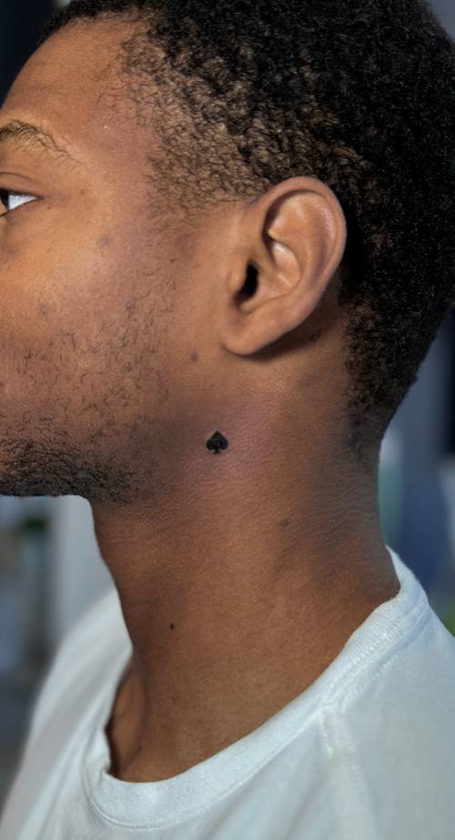 Client with a small tattoo behind the ear by Amina at KAZENTATTOO, Los Angeles