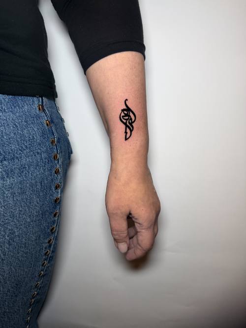 Snake symbol on the wrist, fine line tattoo by Amina at KAZENTATTOO, Los Angeles