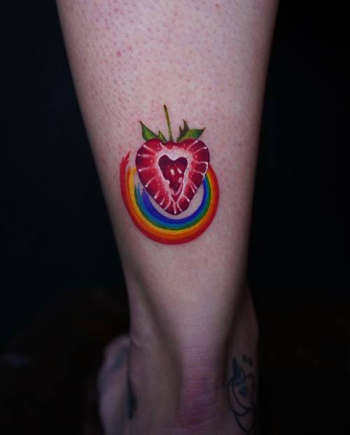 Colour strawberry on the leg by Amina at KAZENTATTOO, Los Angeles