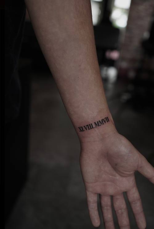 Script bracelet around the wrist by Amina at KAZENTATTOO, Los Angeles, second view