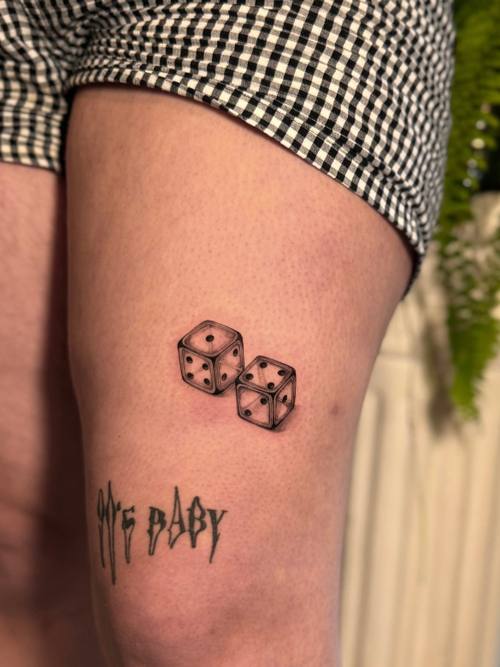 Pair of dice with lettering on the thigh by Amina at KAZENTATTOO, Los Angeles, second view