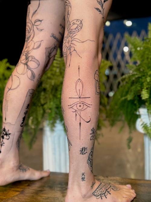 Fine line ornaments down the leg by Amina at KAZENTATTOO, Los Angeles