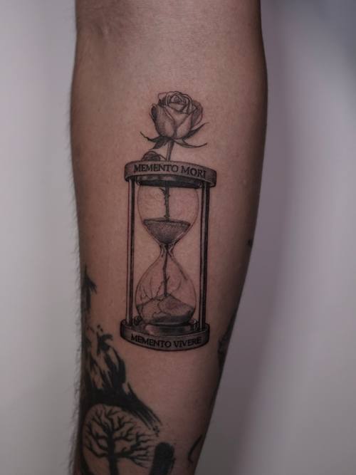 Hourglass with a rose on the calf, fine line tattoo by Amina at KAZENTATTOO, Los Angeles