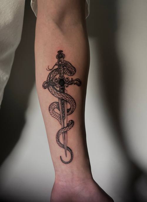 Snake coiled around a dagger with a rose, forearm tattoo by Amina at KAZENTATTOO, Los Angeles