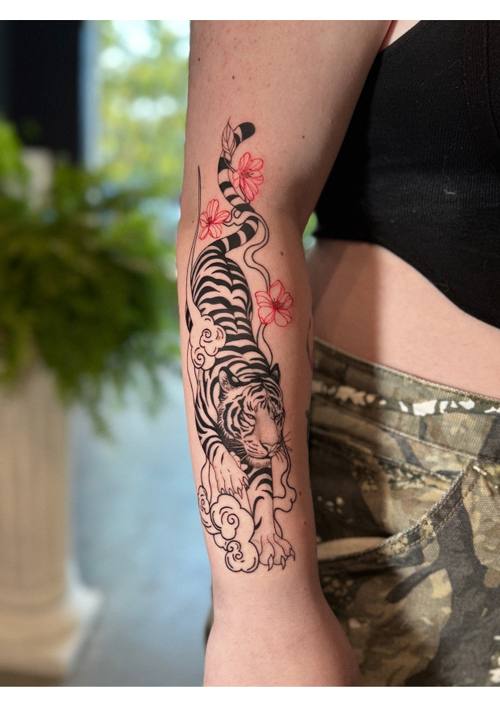 Tiger with red accents on the arm by Amina at KAZENTATTOO, Los Angeles