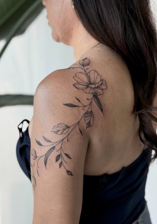 Botanical branch across the shoulder seen from the back by Amina at KAZENTATTOO, Los Angeles, third view