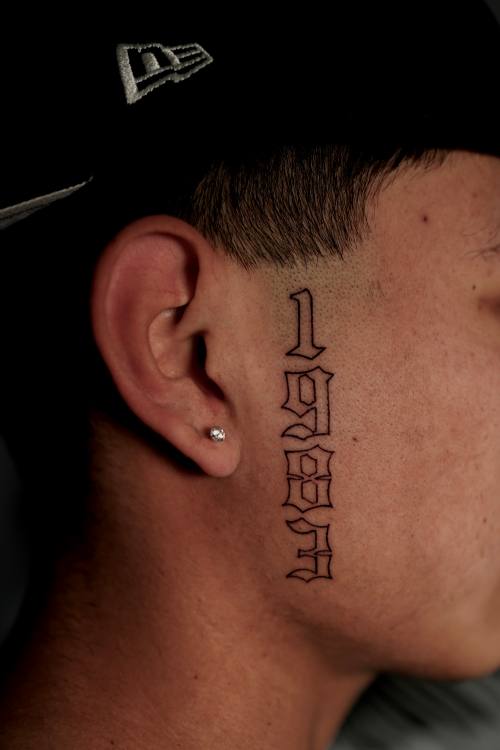 Script behind the ear, fine line tattoo by Amina at KAZENTATTOO, Los Angeles