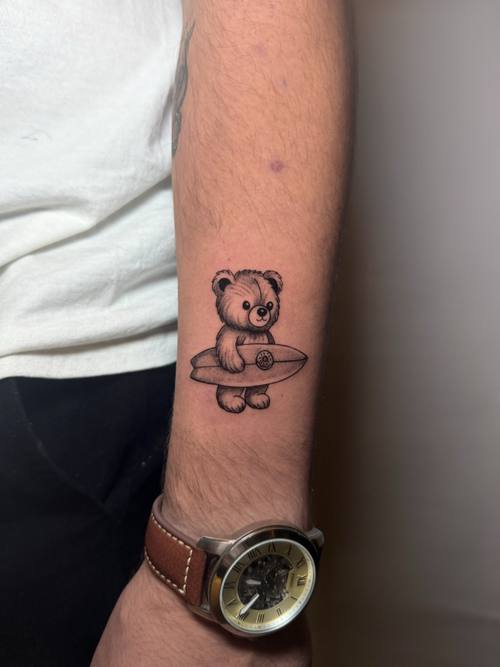 Small bear on the forearm, fine line tattoo by Amina at KAZENTATTOO, Los Angeles