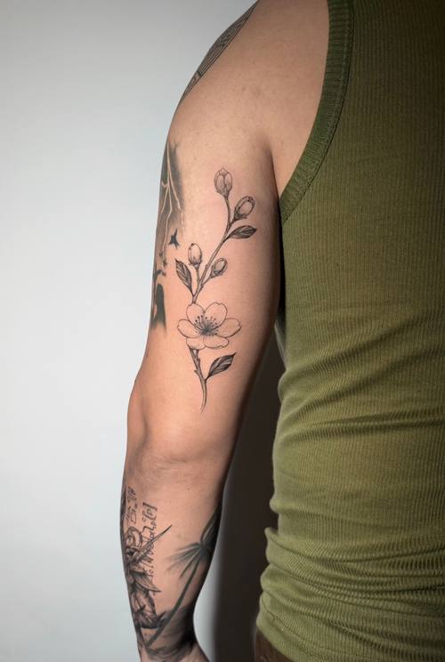 Botanical branch along the arm, fine line tattoo by Amina at KAZENTATTOO, Los Angeles