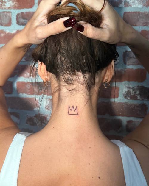 Small lettering at the nape of the neck, fine line tattoo by Amina at KAZENTATTOO, Los Angeles