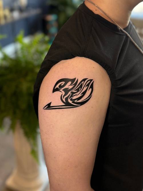 Bird in flame on the shoulder, black and grey tattoo by Amina at KAZENTATTOO, Los Angeles