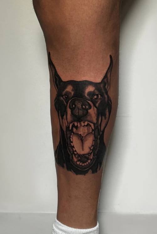 Rottweiler portrait on the calf, black and grey tattoo by Amina at KAZENTATTOO, Los Angeles