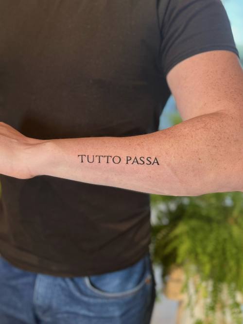 Script reading Tutto Passa on the forearm by Amina at KAZENTATTOO, Los Angeles