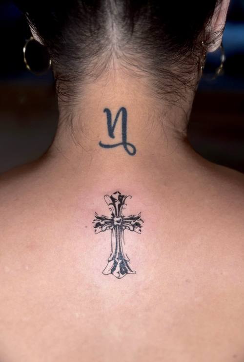 Zodiac symbol with a cross at the nape of the neck, fine line tattoo by Amina at KAZENTATTOO, Los Angeles
