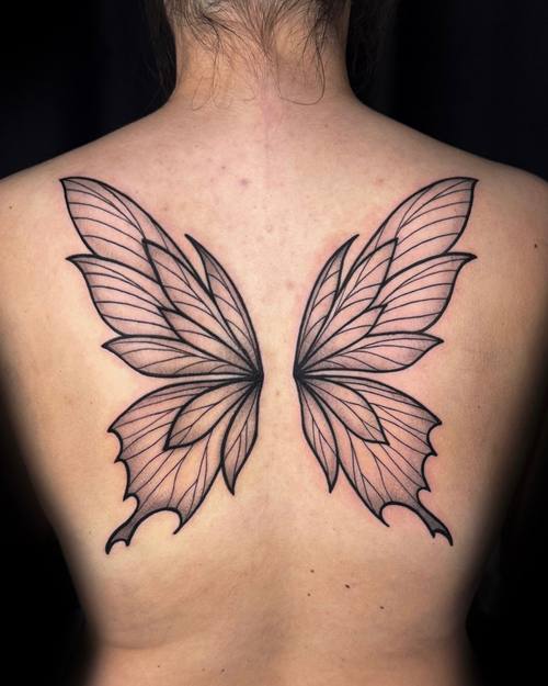 Butterfly wings spread across the upper back, fine line tattoo by Amina at KAZENTATTOO, Los Angeles