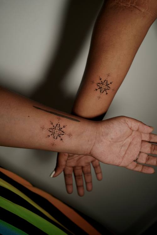 Sun motifs on the forearm and the hand, fine line tattoos by Amina at KAZENTATTOO, Los Angeles