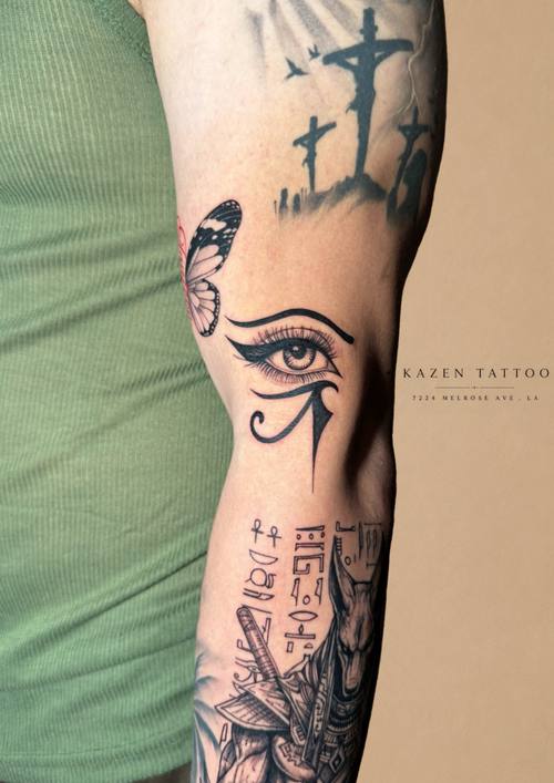 Sleeve with an eye, a cross and lettering, fine line tattoo by Amina at KAZENTATTOO, Los Angeles