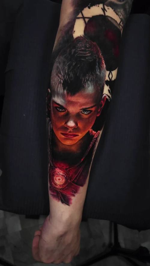 Young warrior's portrait in red light, colour realism arm tattoo by Livio at KAZENTATTOO, Los Angeles