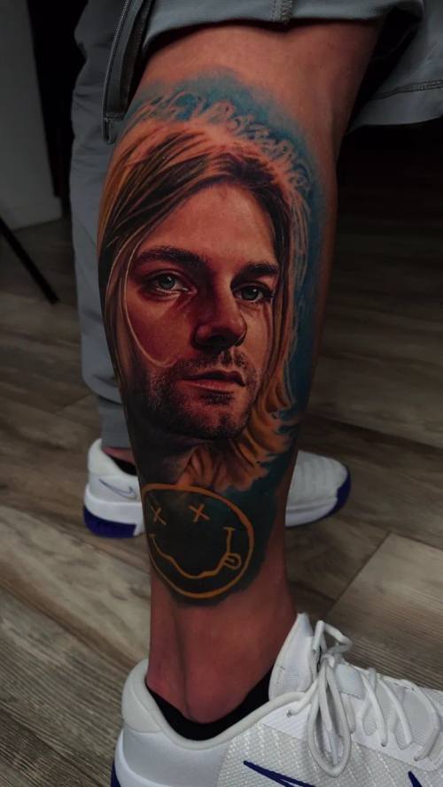 Blond musician's portrait, colour realism calf tattoo by Livio at KAZENTATTOO, Los Angeles