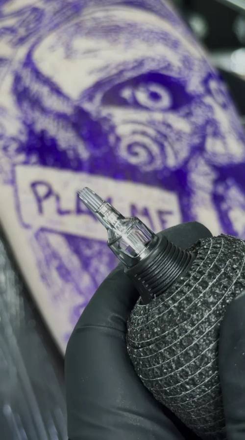 Eye design drawn on paper next to a tattoo machine, studio shot at KAZENTATTOO, Los Angeles