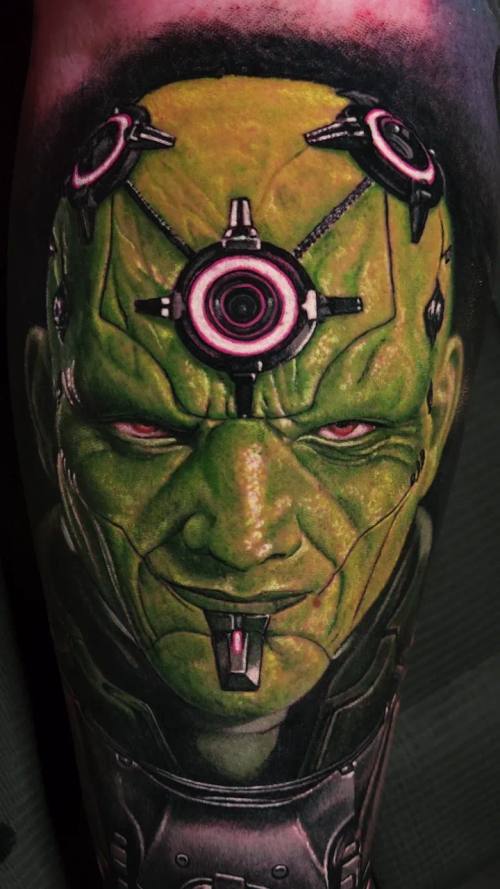Green-skinned villain with a device on his forehead, colour realism calf tattoo by Livio at KAZENTATTOO, Los Angeles