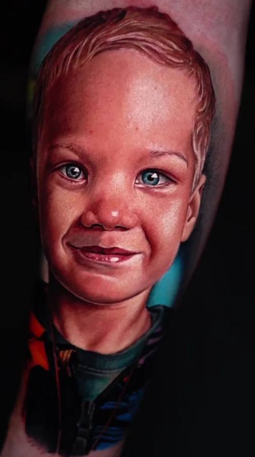 Crying child's portrait, colour realism calf tattoo by Livio at KAZENTATTOO, Los Angeles