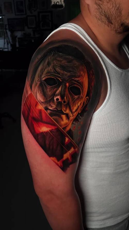 Burning skull mask in flames, colour realism shoulder tattoo by Livio at KAZENTATTOO, Los Angeles