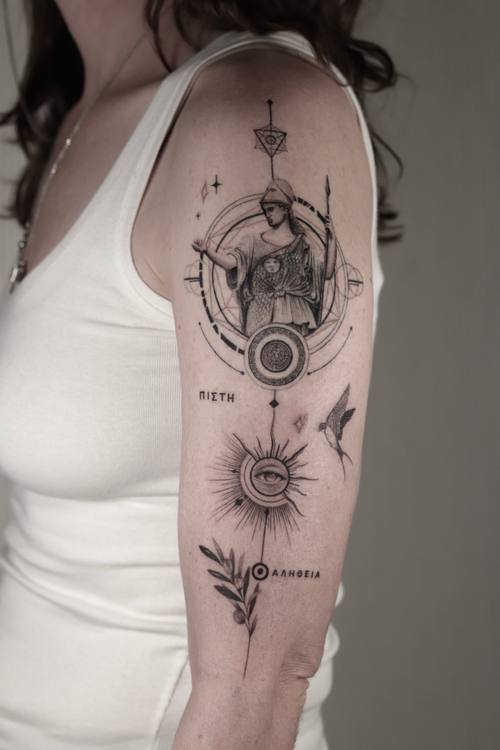 Fine line column of esoteric symbols with a figure, sun and olive branch, upper arm tattoo by Marrie at KAZENTATTOO, Los Angeles