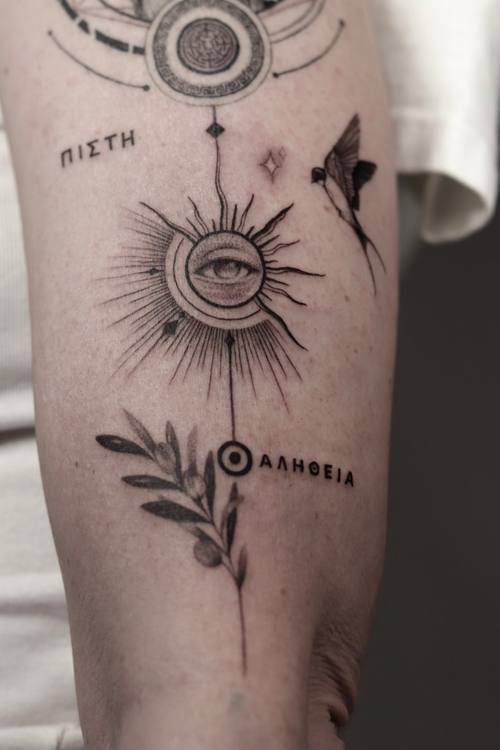 Sun with an eye, olive branch and Greek lettering, fine line upper arm tattoo by Marrie at KAZENTATTOO, Los Angeles