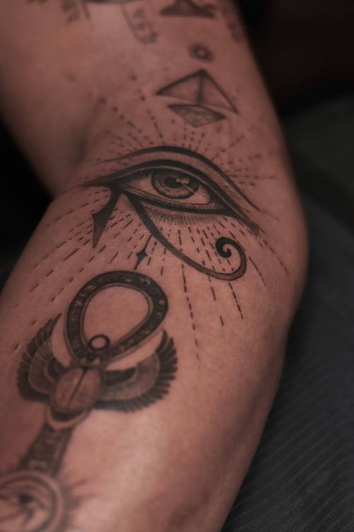 Eye of Horus with an ankh and ornament, fine line arm tattoo by Marrie at KAZENTATTOO, Los Angeles
