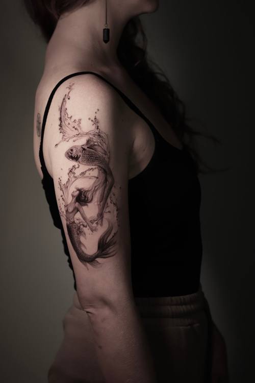 Moth and delicate botanical work along the upper arm, fine line tattoo by Marrie at KAZENTATTOO, Los Angeles