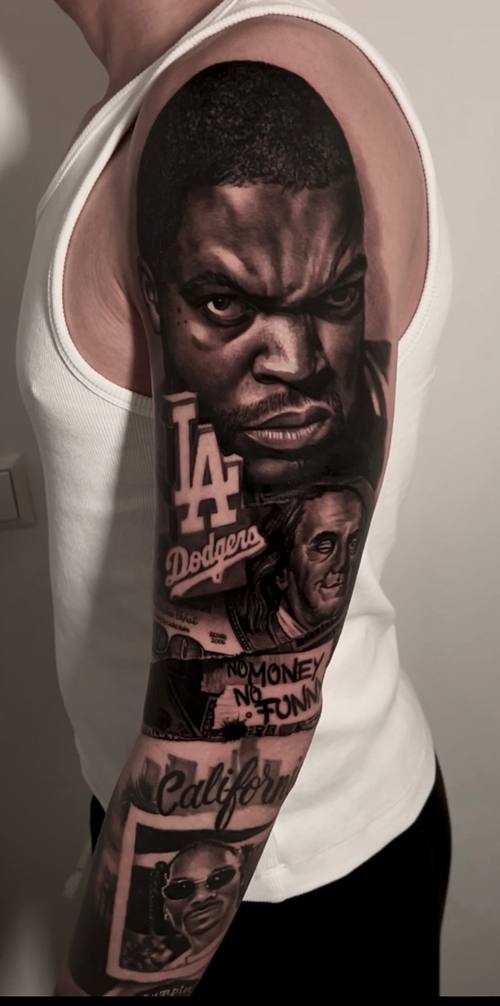 Portrait of a rapper with a Los Angeles cap and lettering, black and grey upper arm tattoo by Marko at KAZENTATTOO, Los Angeles