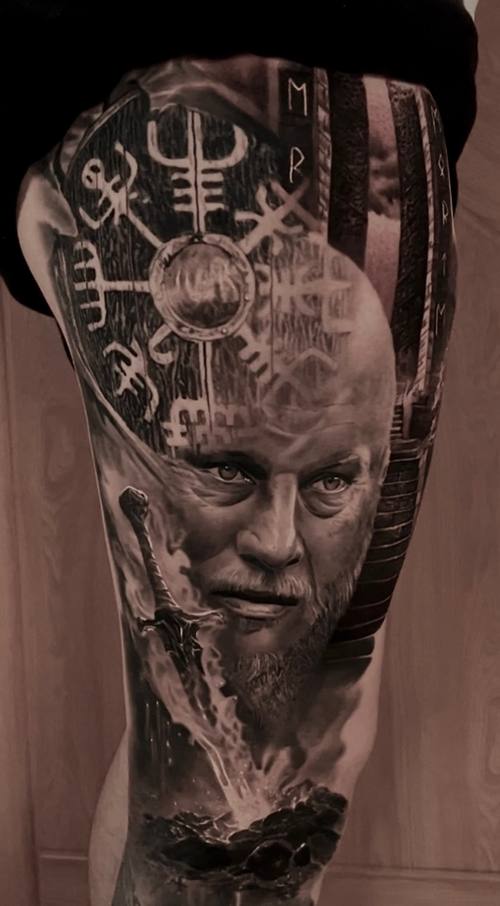 Young man's portrait with Norse runes and a compass, black and grey thigh tattoo by Marko at KAZENTATTOO, Los Angeles