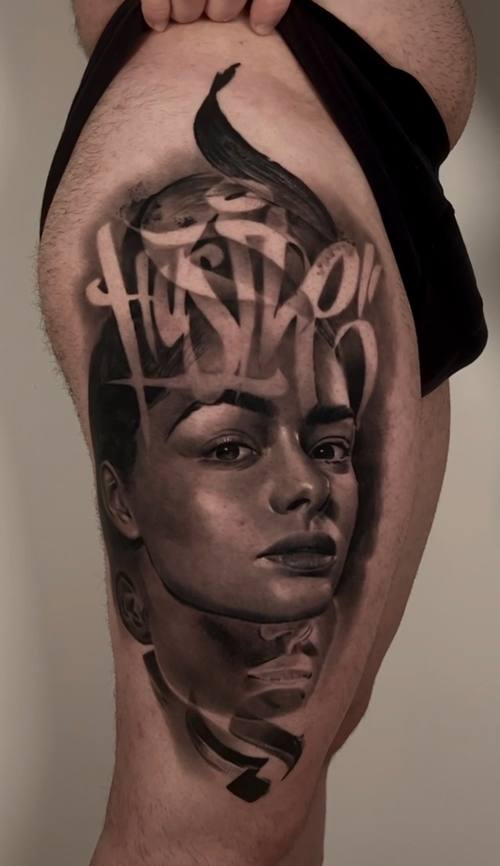 Woman's portrait with graffiti lettering, black and grey upper arm tattoo by Marko at KAZENTATTOO, Los Angeles
