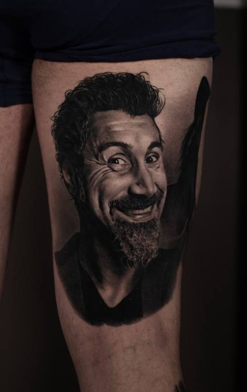 Smiling bearded man's portrait, black and grey realism thigh tattoo by Marko at KAZENTATTOO, Los Angeles