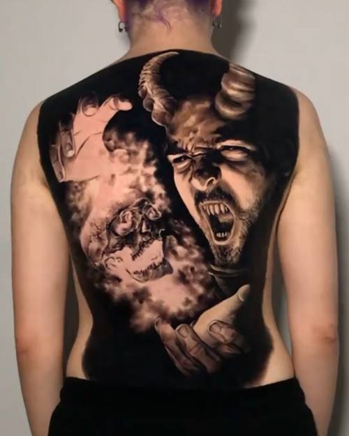 Horned figure screaming out of torn skin, black and grey full back tattoo by Nihat at KAZENTATTOO, Los Angeles