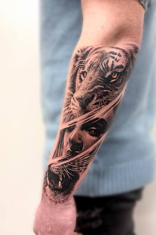 Wolf and dog faces in black and grey realism with color accents on the forearm by Padre at KAZENTATTOO, Los Angeles