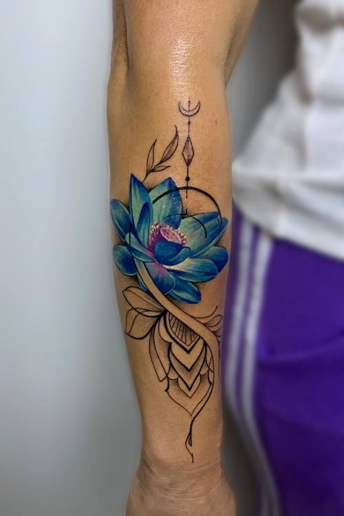 Color lotus with fine line ornamental details on the forearm by Padre at KAZENTATTOO, Los Angeles