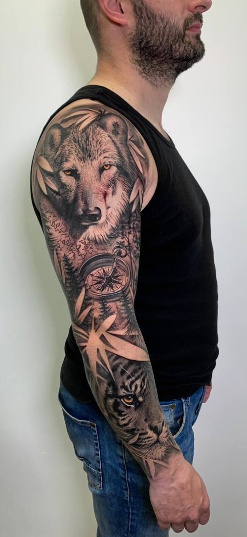 Black and grey full sleeve with wolf, compass and tiger on the arm by Padre at KAZENTATTOO, Los Angeles