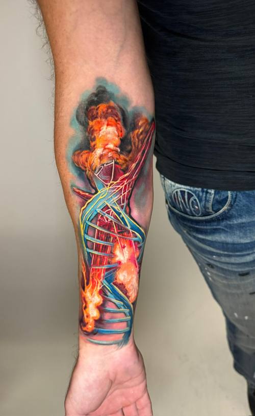 Surreal color DNA double helix with flames on the forearm by Padre at KAZENTATTOO, Los Angeles