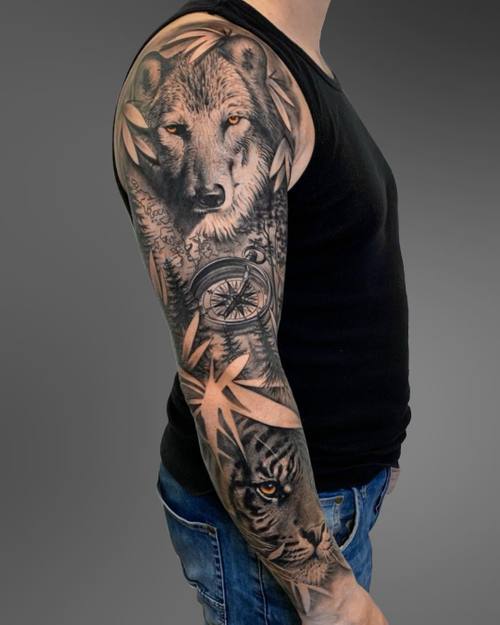 Black and grey full sleeve with wolf, compass and tiger on the arm by Padre at KAZENTATTOO, Los Angeles