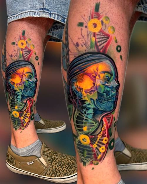 Surreal color skull face with DNA double helix and circuit patterns on the calf by Padre at KAZENTATTOO, Los Angeles